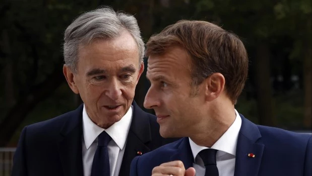 El director ejecutivo del conglomerado de lujo LVMH, Bernard Arnault, izquierda, y el presidente francés, Emmanuel Macron.